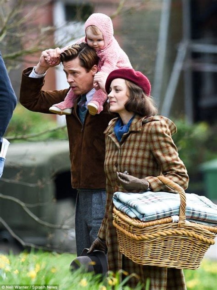 Brad Pitt plays a doting parent with Marion Cotillard on set in London